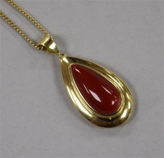 An Italian 18ct gold and pear shaped coral drop pendant, on an 18ct gold chain, pendant overall 33mm.